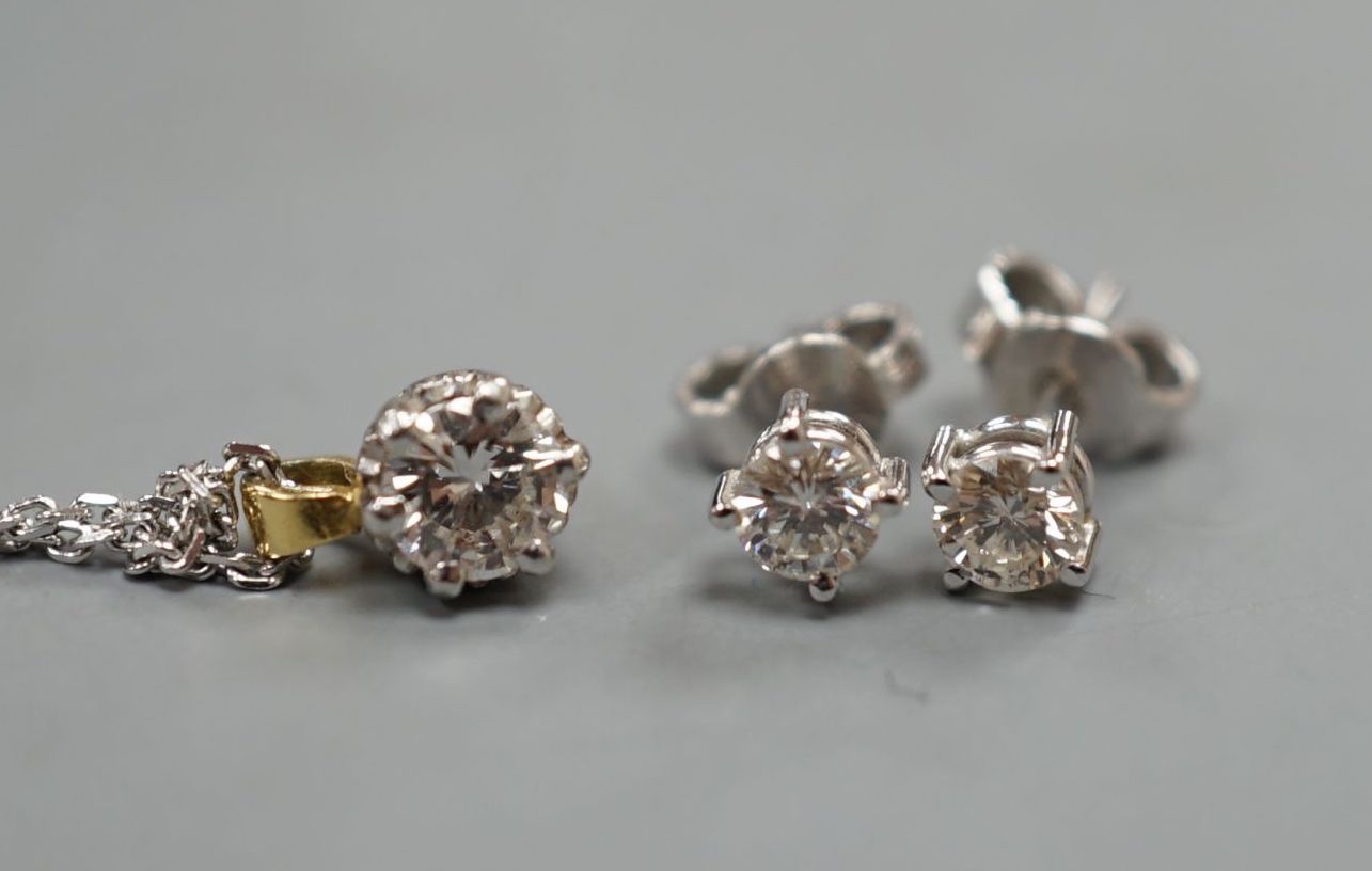 A pair of 18ct and solitaire diamond set ear studs, gross 1 grams and a solitaire diamond pendant on a 375 chain, gross 2.5 grams.